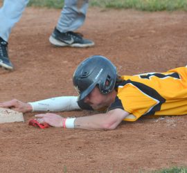 Parker Dorrance dives back into third base during action against the Swift Current 57’s on Tuesday night. Joe Gunnis